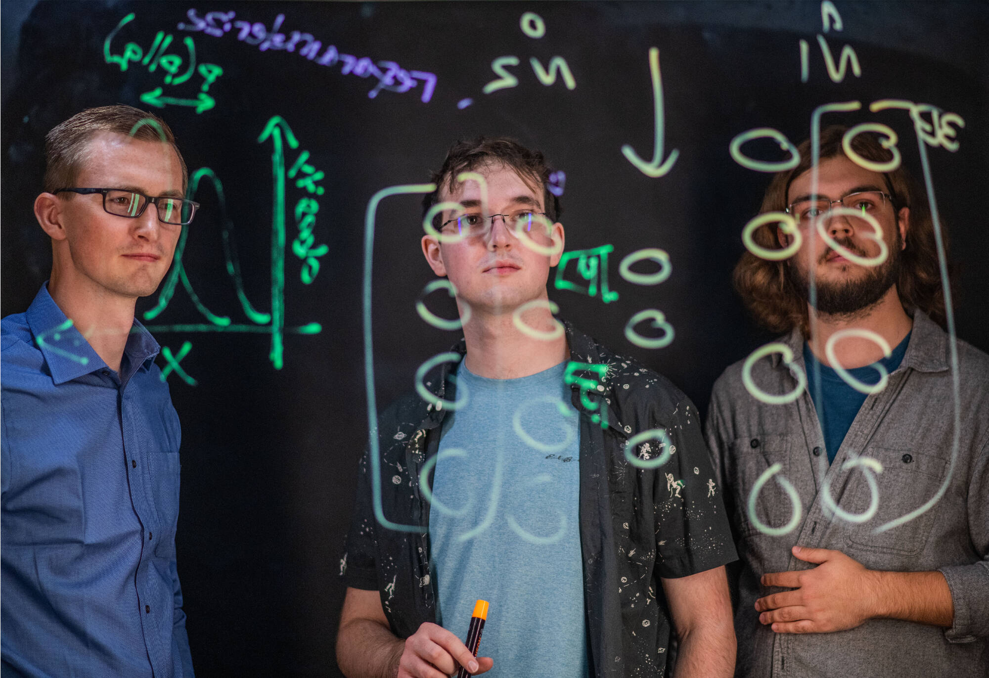 Zachary DeBruine, left, is an assistant professor of computing. Students, from left, are Seth Wolfgang and Skylar Ruiter(Photo releases on file)